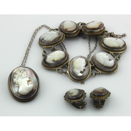 517 - Silver mother of pearl cameo matching jewellery suite to include one seven panelled bracelet, pendan... 