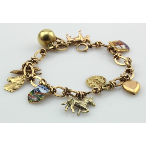 529 - 9ct gold fancy linked bracelet with as assortment of nine 9ct gold and tests 14ct gold charms, lengt... 