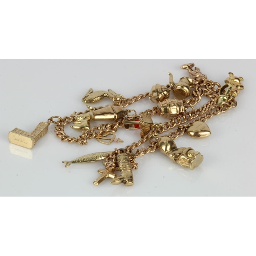 530 - Yellow metal (test 9ct) pocket watch chain with an assortment of 9ct / yellow metal charms attached.... 