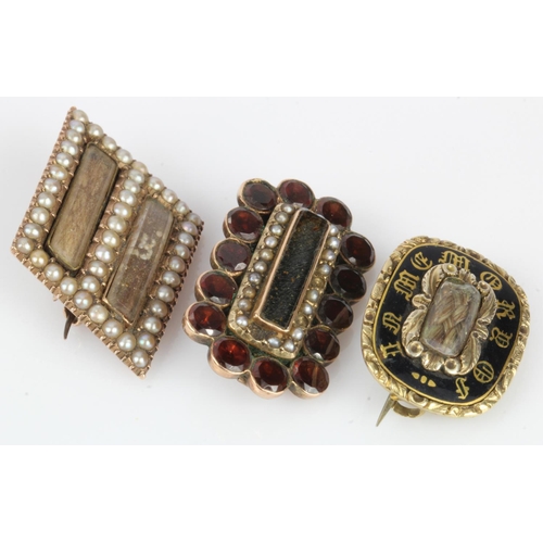 572 - Three yellow metal mourning brooches, stones include garnet and seed pearls, two with some damage, t... 