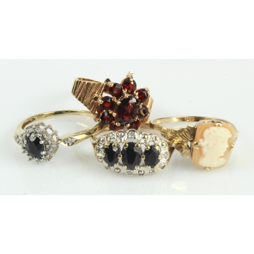 595 - Four 9ct gold/tests 9ct dress rings, stones include diamond, sapphire, garnet and carved shell, fing... 