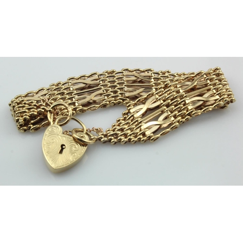 618 - 9ct yellow gold seven bar gate bracelet, with heart padlock and safety chain, length 7