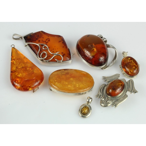 638 - Assortment of silver set amber jewellery, three brooches and four pendants, total weight 75.5g.