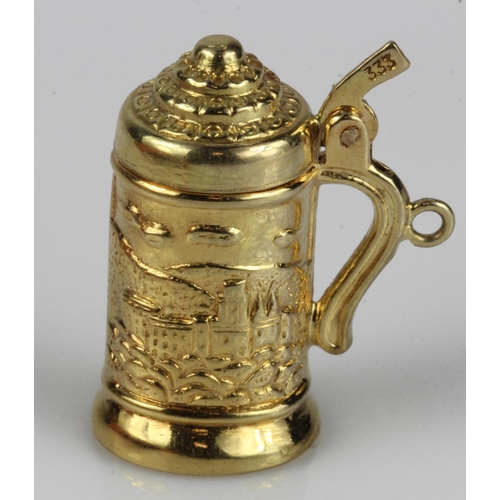 641 - Yellow gold (tests 8ct) Heidelberg tankard charm, articulated lid, weight 3.6g.