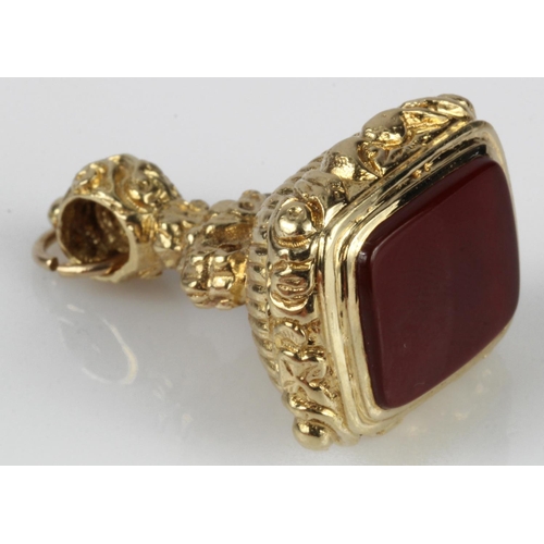 645 - 9ct yellow gold pocked watch fob seal, set with carnelian, length 35mm, weight 20.3g.