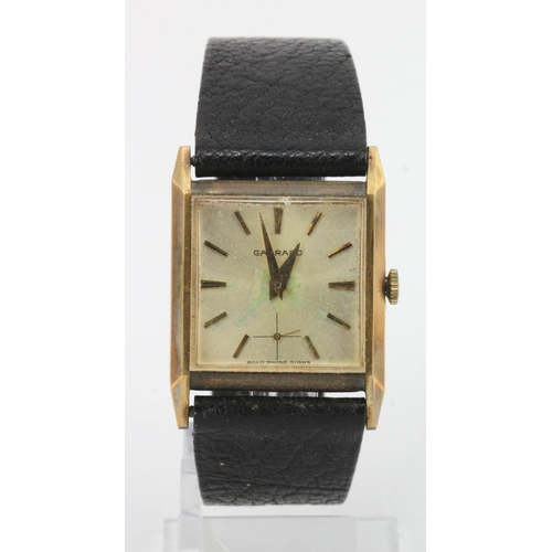 717 - Gents 9ct cased Garrards manual wind wristwatch. The square silver dial with gilt baton markers and ... 