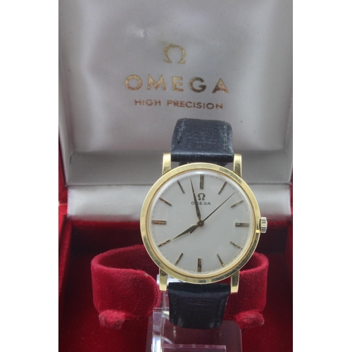 719 - Gents 18ct cased Omega manual wind wristwatch. The cream dial with gilt baton markers. On an Omega l... 