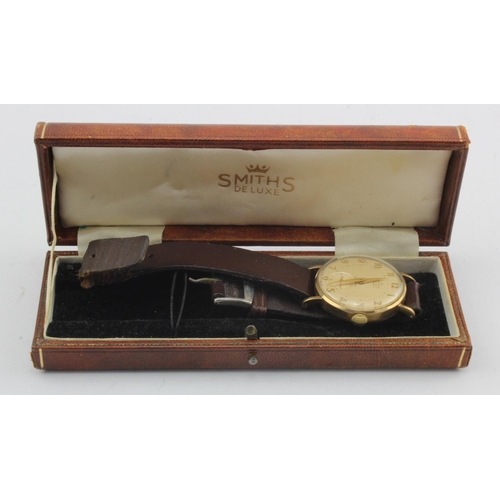 727 - Gents 9ct cased Smiths De Luxe manual wind wristwatch, hallmarked 1962. The cream dial with Arabic n... 