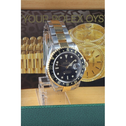 735 - Gents Stainless steel cased Rolex GMT - Master II, circa 2000, The black and gold dial with black an... 