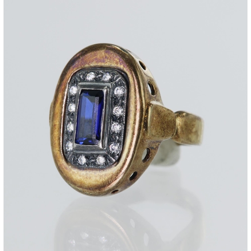 81 - Yellow gold (tests 14ct) dress ring, set with one synthetic sapphire and CZs, head measures 22mm x 1... 