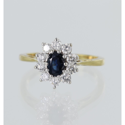 83 - 18ct yellow gold diamond and sapphire cluster ring, oval sapphire measures 6mm x 4mm, surrounded by ... 