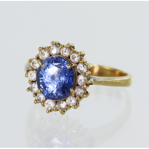 84 - Yellow gold (tests 18ct) sapphire and white topaz cluster ring, one cornflower blue sapphire measure... 