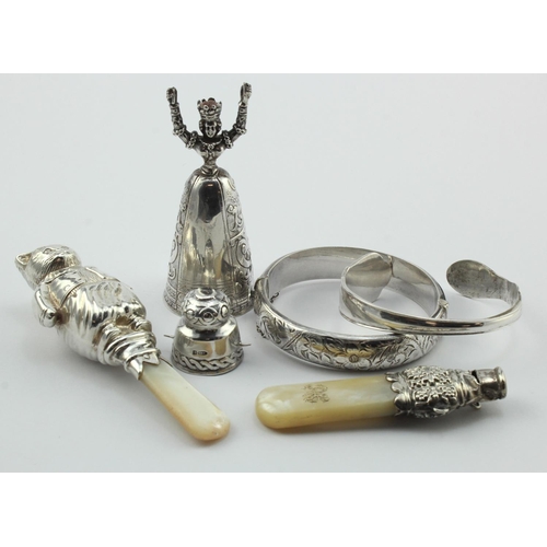 978 - Mixed lot of silver, two silver & mother of pearl babies' rattles, one in the shape of a cat and pos... 