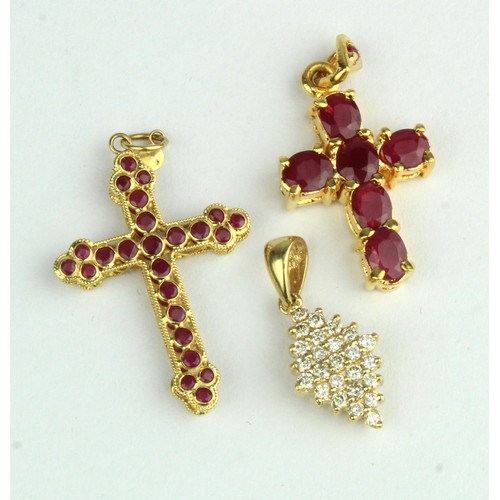 395 - Three yellow gold (tests 18ct) pendants, stones include diamond and ruby, total weight 5.8g.