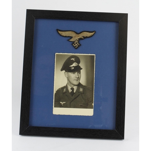 1180 - German framed photo of a Luftwaffe air man with breast eagle above.