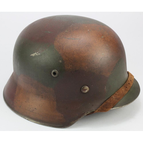 1224 - German M35 combat helmet with old liner and chin strap, maker marked ET. Normandy type camo.