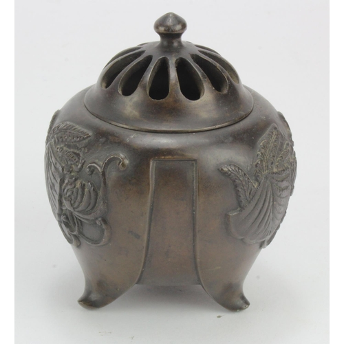 1061 - Oriental bronze censor, embossed decoration, raised on three feet, height 95mm approx.