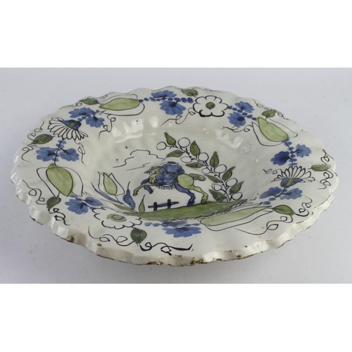 686 - Delft 17th Century dish, depicting a figure on horseback to centre, surrounded by floral decoration,... 