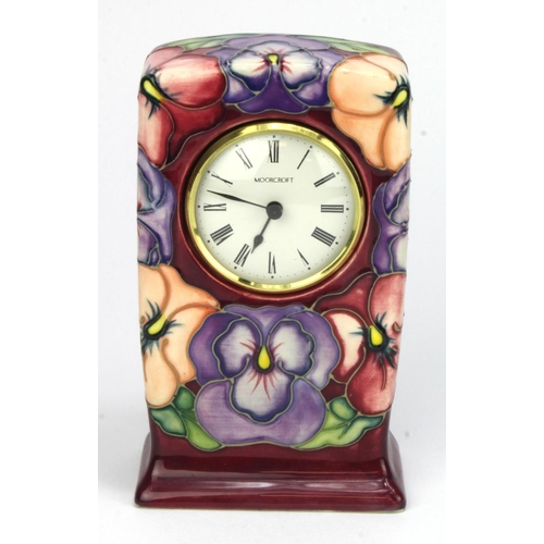 713 - Moorcroft Pottery Pansey pattern mantel clock, makers marks to base, height 15.5cm approx.