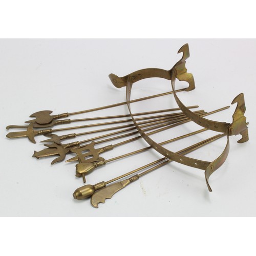 1049 - Military interest. A set of ten brass skewers, contained in original stand, stand engraved 'Presente... 