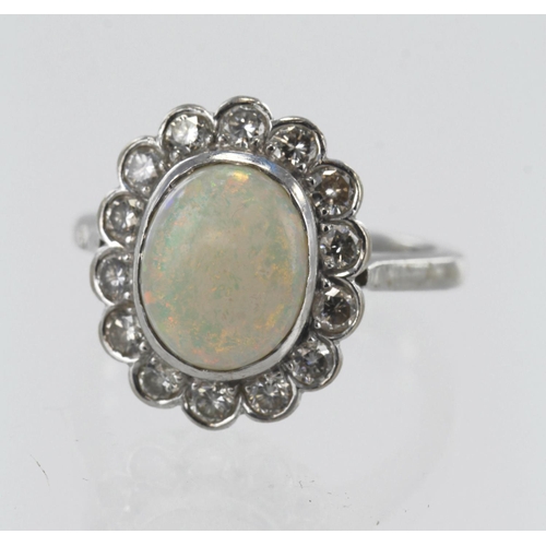 1 - White gold (tests 18ct) opal and diamond cluster ring, one oval cabochon opal measuring approx. 10.5... 