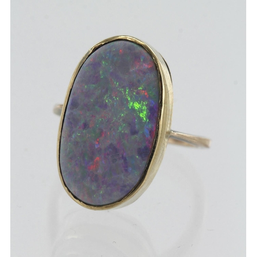 11 - Yellow gold (tests 9ct) opal doublet dress ring, oval doublet measures 20mm x 11mm, bezel setting, f... 