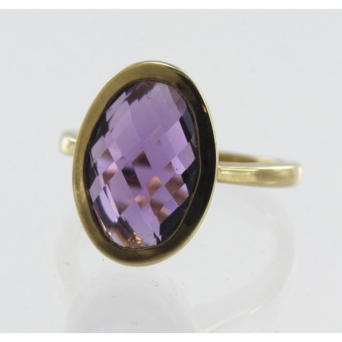 116 - 9ct yellow gold amethyst cocktail ring, oval checker cut amethyst measures approx. 13mm x 8.5mm, bez... 