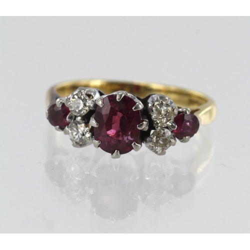 121 - Yellow gold (tests 18ct) diamond and ruby ring, three rubies, principle measures approx. 6mm x 5mm, ... 