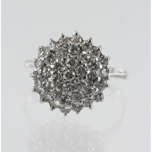 131 - White gold (tests 18ct) diamond cluster ring, thirty-seven round brilliant cut diamonds, TDW approx.... 