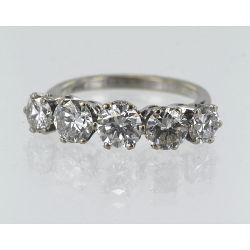 149 - White gold (tests 18ct) diamond five stone ring, five graduating round brilliant cuts, principle app... 