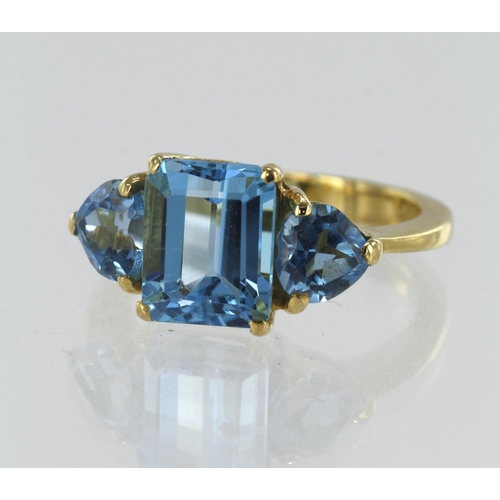 169 - Yellow gold (tests 18ct) Swiss blue topaz dress ring, principle step cut topaz measures 10mm x 8mm, ... 