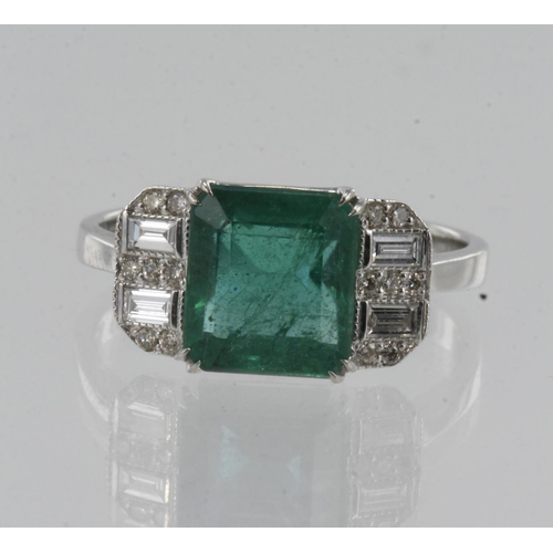 18 - White gold (tests 18ct) diamond and emerald dress ring, one step cut emerald approx. 2.25ct, flanked... 