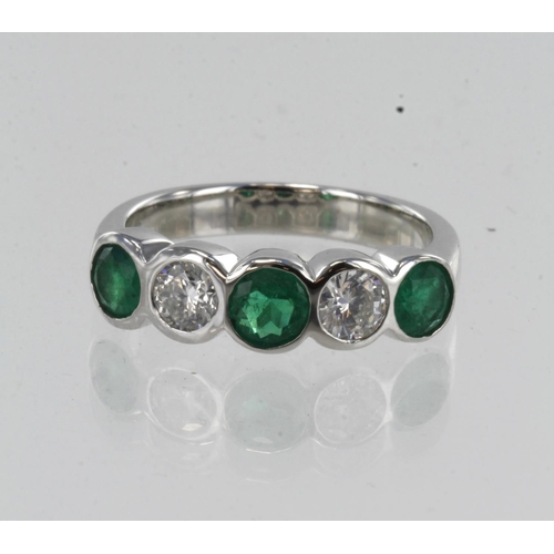 195 - White gold (tests 18ct) diamond and emerald five stone ring, three round emeralds approx. 4.5mm, two... 