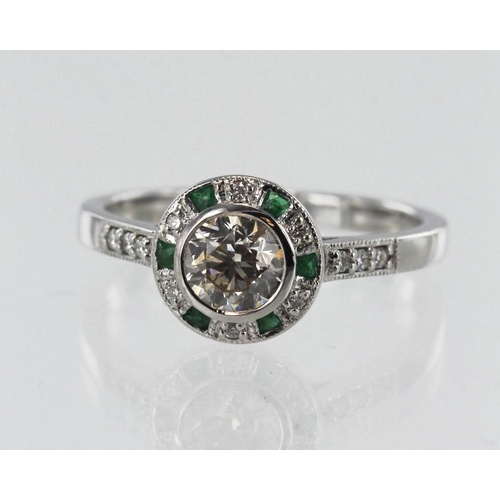 23 - White gold (tests 18ct) diamond and emerald target halo ring, principle round brilliant cut approx. ... 