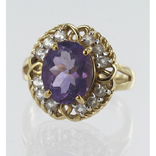 34 - 9ct yellow gold amethyst and white topaz cluster ring, one oval amethyst approx. 2.779ct, twelve top... 