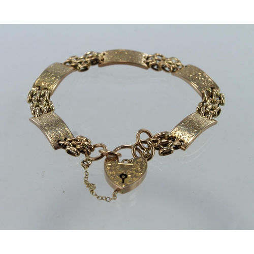 613 - Yellow gold (tests 9ct) vintage three bar gate bracelet, five foliate engraved panels with an engrav... 