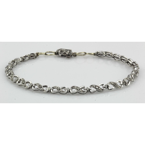 629 - 9ct white gold diamond set infinity bracelet, each linked is spaced and highlighted with one diamond... 