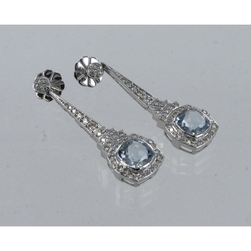 641 - A pair of White gold (tests 18ct) diamond and aquamarine drop stud earrings, one cushion aquamarine ... 