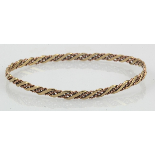 642 - 9ct yellow and rose Clogau gold lovers twist slave bangle, width 4mm, inside diameter approx. 65mm, ... 