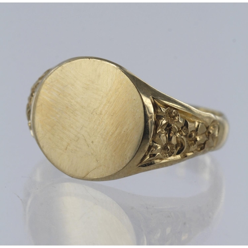 83 - 9ct yellow gold signet ring, circular table diameter approx. 12mm, engraved foliate shoulders, finge... 