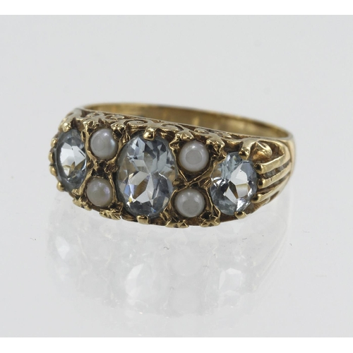 99 - 9ct yellow gold aquamarine and pearl boat shaped ring, three graduating oval aquamarines, principle ... 