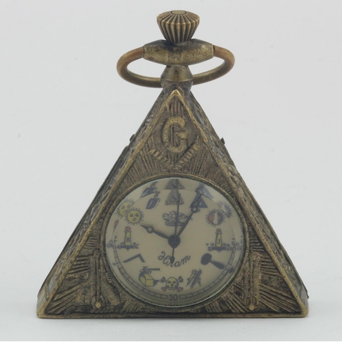 210 - Brass Masonic triangle pocket watch. Approx 5.5cm tall (inc winder) working when catalogued