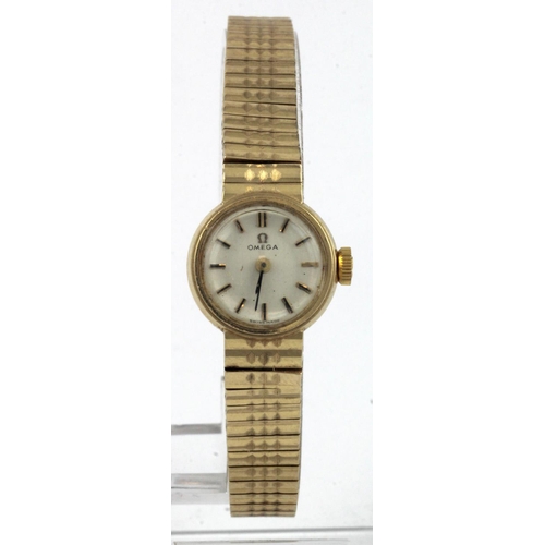 26 - Ladies  9ct gold cased Omega wristwatch, circa 1966. The white dial with baton markers, on an integr... 