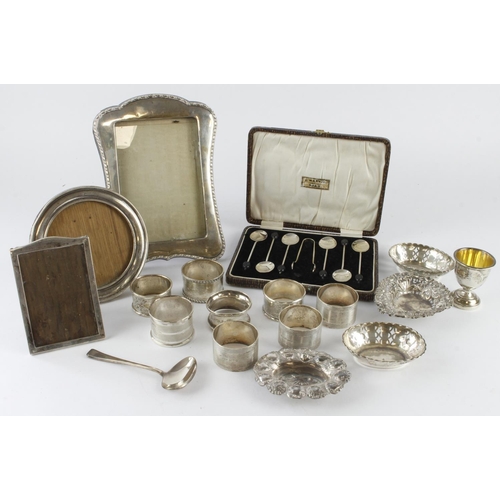 321 - Mixed silver. A collection of various silver, including napkin rings, pin trays, picture frames, spo... 