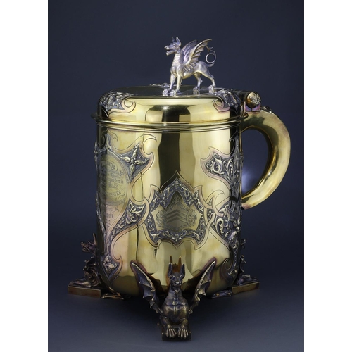 339 - Tankard. A very large exquisite Victorian tankard trophy by Garrard, raised on three dragon feet, wi... 