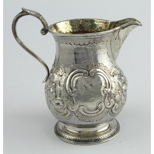 384 - George I / II silver ornately decorated trophy jug, hallmarked 'Dublin 1727', engraved to side 'Tred... 