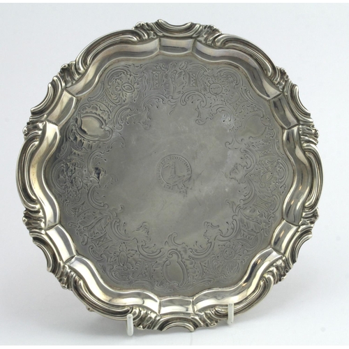 385 - Victorian silver tray, raised on three feet, ornately decorated, crest to centre, hallmarked 'WKR, L... 