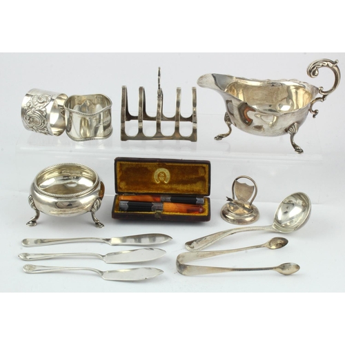 394 - Mixed Silver. A collection of various hallmarked silver items, including toast rack, sugar tongs, na... 