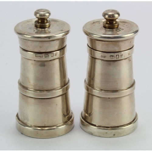 411 - Silver pair of churn shaped salt & pepper grinders, hallmarked 'WW, London 1997 / 1998', height 90mm... 