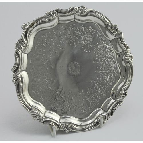 416 - Victorian silver tray, raised on three feet, ornately decorated, crest to centre, hallmarked 'WKR, L... 